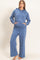 woman wearing a blue hoodie with a front pocket and matching wide-leg sweatpants