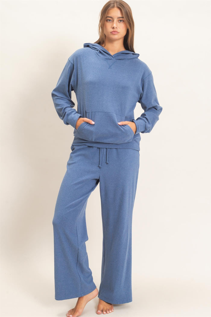 woman wearing a blue hoodie with a front pocket and matching wide-leg sweatpants