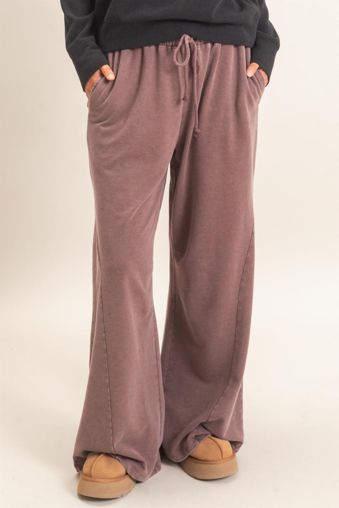 woman wearing comfortable mauve wide-leg lounge pants with pockets and drawstring waist