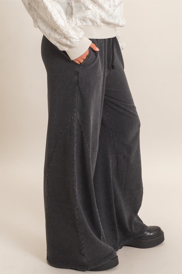 woman wearing gray wide-leg sweatpants with pockets and a relaxed fit