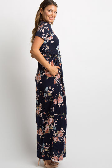 Pregnant woman wearing a navy blue floral print short sleeve maternity maxi dress
