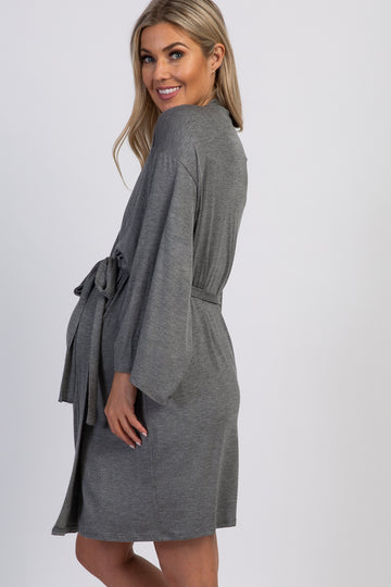 woman wearing a gray maternity robe with a belt and bell sleeves, showing her baby bump from the side