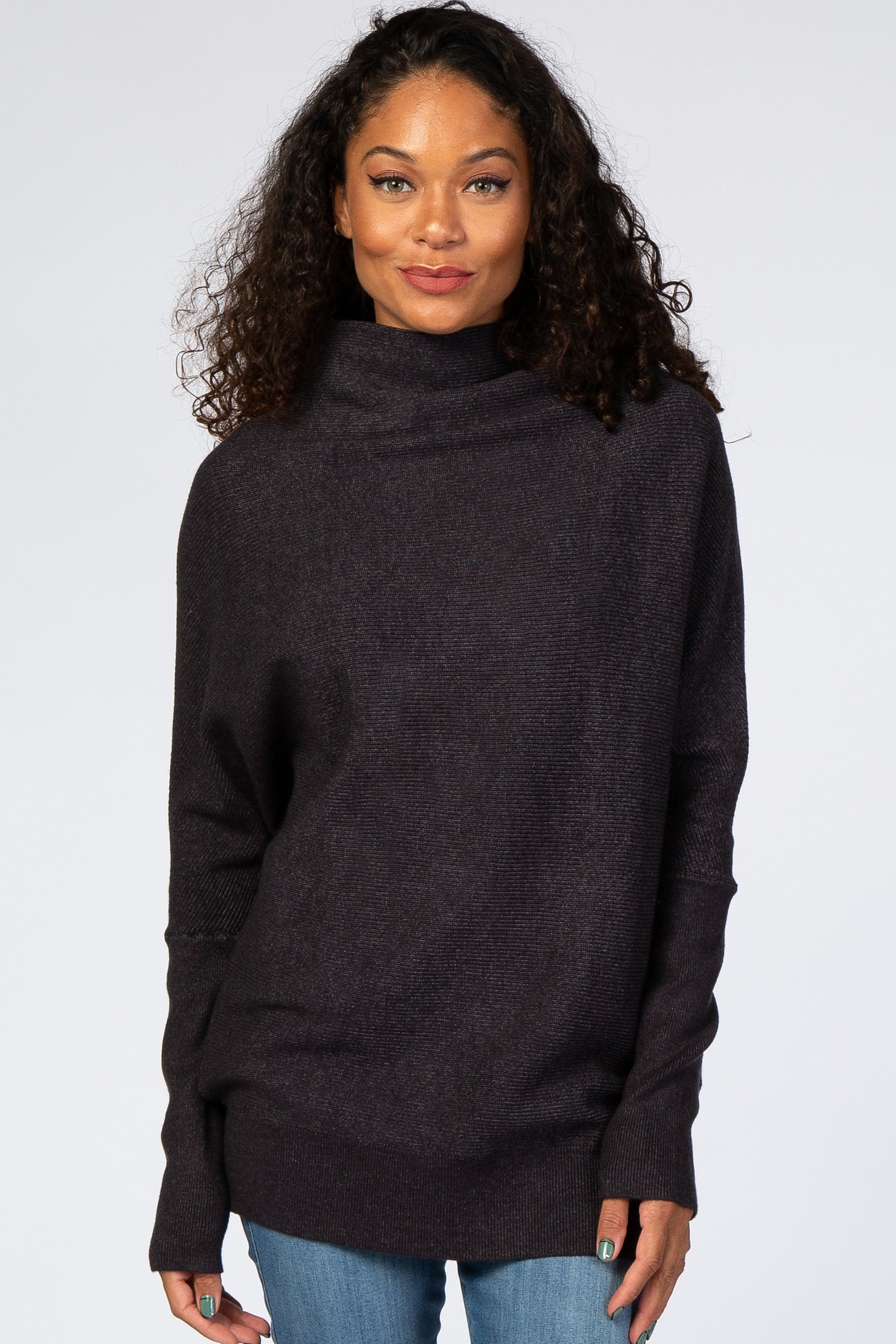 woman wearing a dark purple oversized turtleneck sweater with long sleeves and relaxed fit