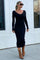 woman wearing a black ribbed long sleeve dress and brown ankle boots, walking outside near a window