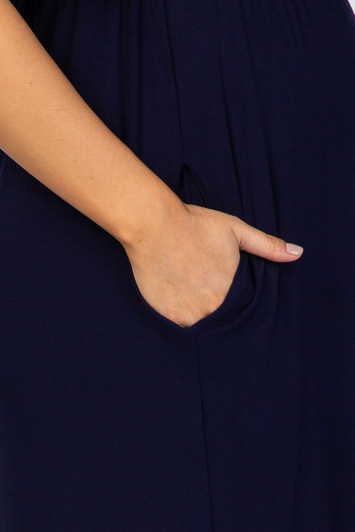 close up of a hand in the side pocket of a navy blue dress