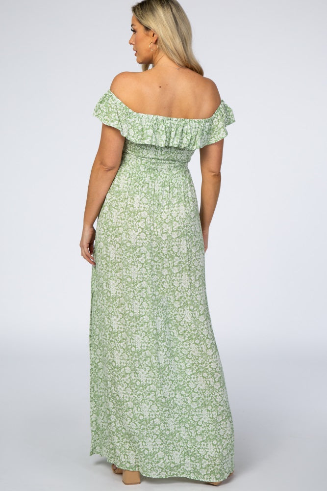 woman wearing a green floral off-the-shoulder maternity maxi dress from the back