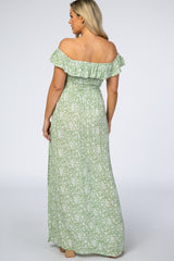 woman wearing a green floral off-the-shoulder maternity maxi dress from the back