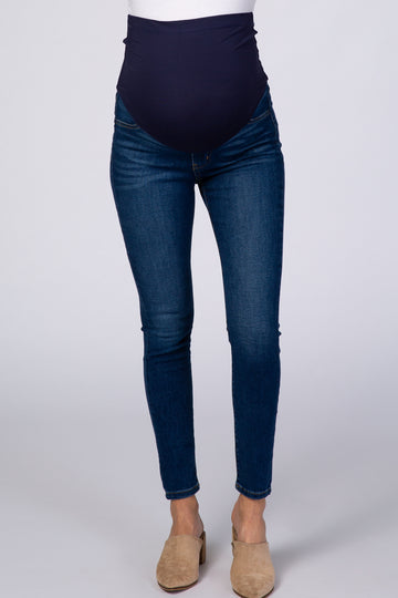 woman wearing dark blue maternity skinny jeans with a high elastic waistband and a fitted style