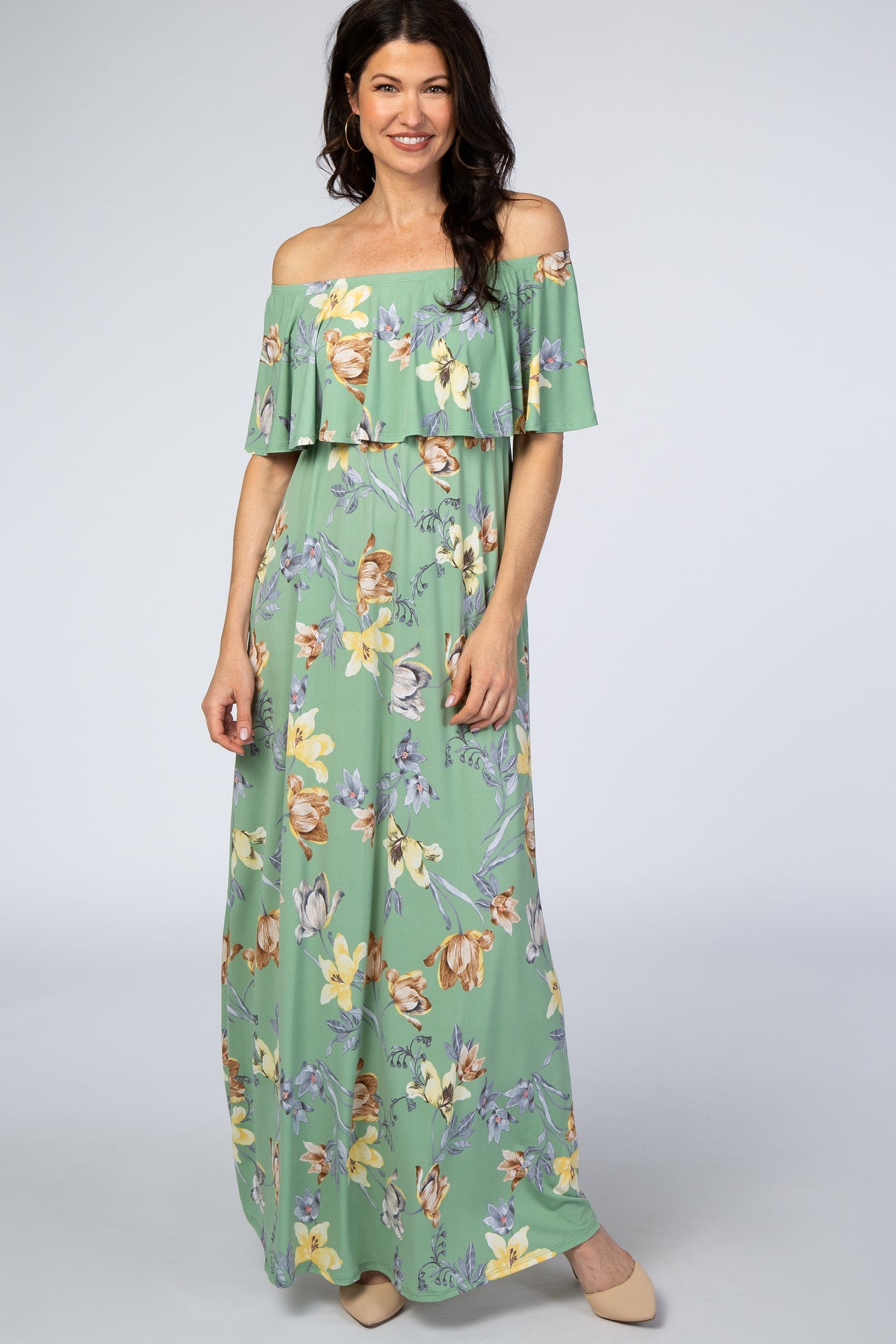 woman wearing a light green off-the-shoulder maxi dress with floral print and ruffle detailing
