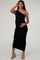 woman wearing a black one-shoulder maternity dress, showing her baby bump with a fitted, ruched design
