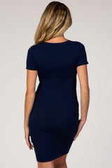 back view of a woman wearing a navy blue short sleeve ribbed maternity dress