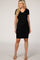 woman wearing a black short sleeve maternity dress with a v-neckline and visible baby bump