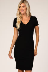 woman wearing a black short sleeve ribbed dress with a v-neckline