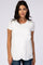 woman wearing a white short sleeve top with an asymmetrical hem and round neckline, styled with blue jeans