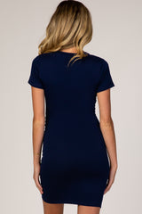 woman wearing a navy blue short sleeve maternity dress, viewed from the back
