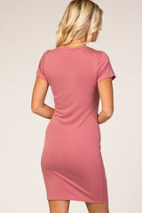 woman wearing a pink short sleeve bodycon dress, showing the back view