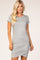 blonde woman wearing a grey short sleeve ruched bodycon dress against a neutral background