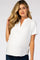 woman wearing a white short sleeve maternity top with a split neckline and visible baby bump