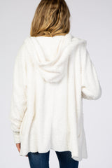 woman wearing a soft white furry maternity hoodie, showing the back view