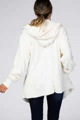 woman wearing a fluffy white hooded pullover sweater with a relaxed fit and deep hemline, seen from the back