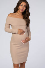 woman wearing a beige off-the-shoulder ribbed maternity dress and holding her baby bump
