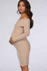 woman wearing a beige off-the-shoulder ribbed maternity dress and showcasing her baby bump