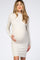 woman wearing a beige long sleeve maternity dress and holding her baby bump