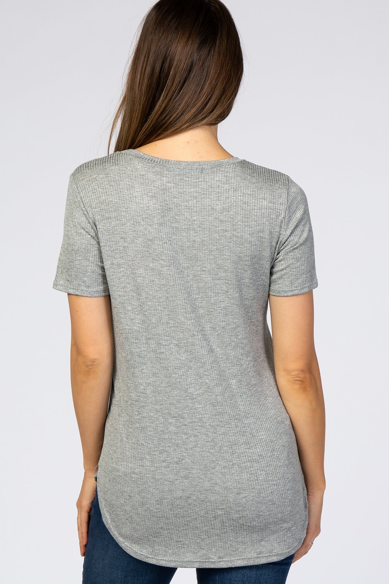 woman wearing a light grey short sleeve maternity top with a rounded hemline, showing a smooth back view