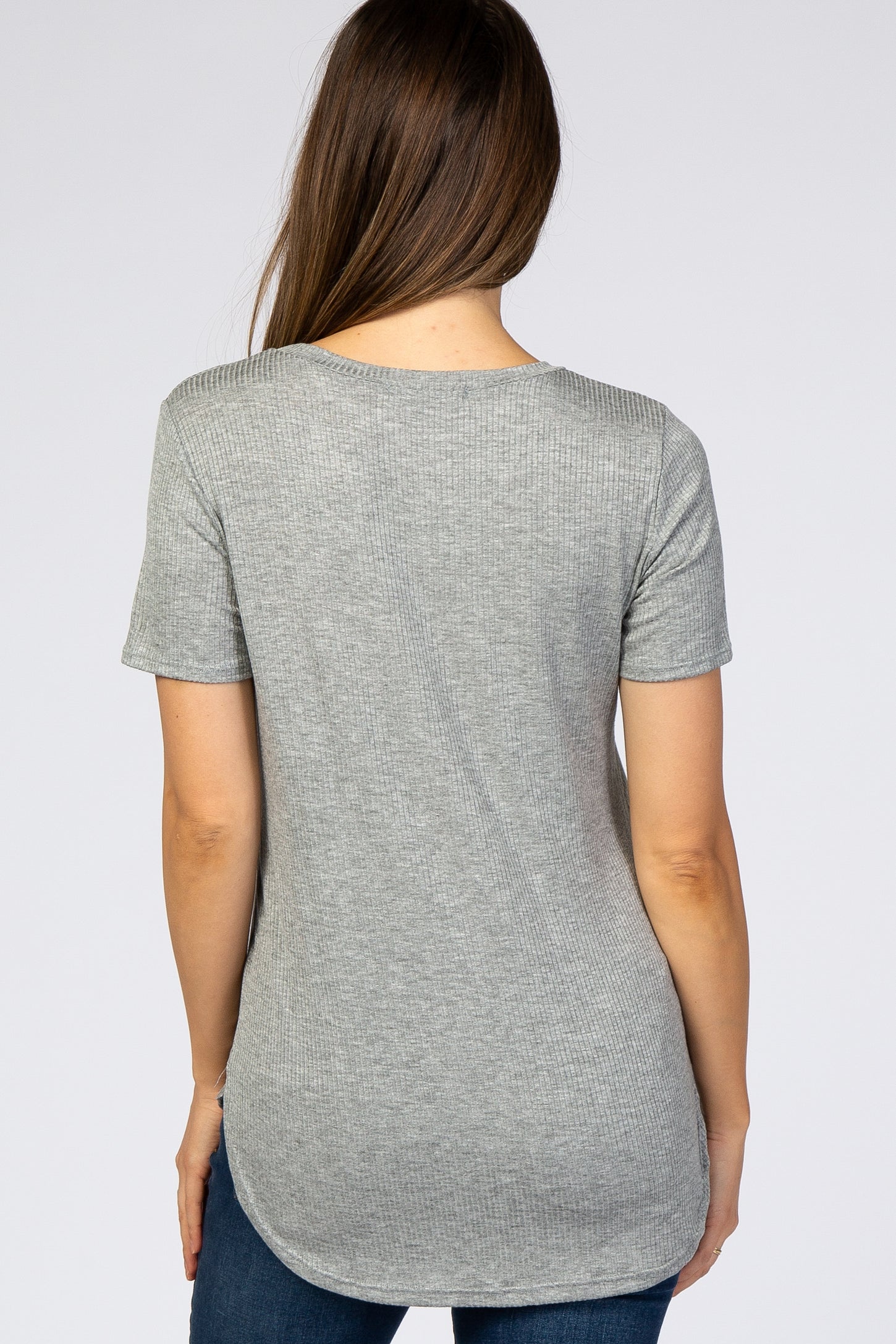 woman wearing a light grey short sleeve maternity top with a rounded hemline, showing a smooth back view