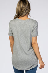 woman wearing a light grey ribbed short sleeve top with a rounded hem and back view showing relaxed fit