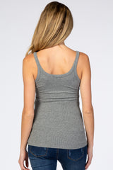 back view of a woman wearing a grey ribbed scoop neck tank top and blue jeans