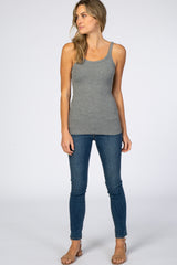 woman wearing a gray ribbed tank top paired with blue skinny jeans and sandals