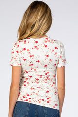 woman wearing a floral maternity top with a fitted style and short sleeves, shown from the back
