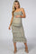 woman wearing a floral print tiered maternity dress with a fitted bodice and holding her baby bump