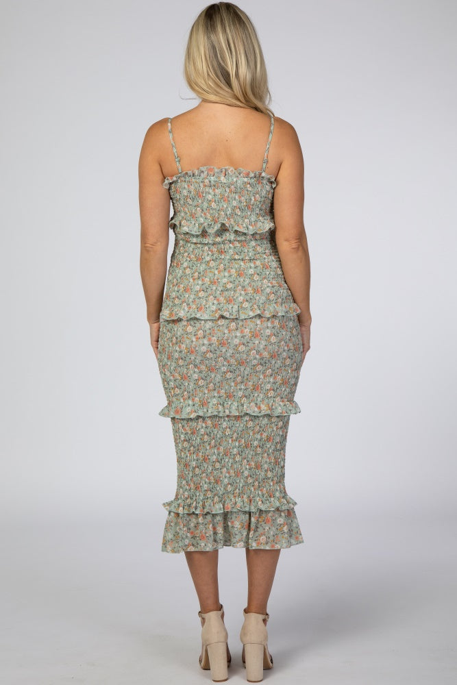 woman wearing a floral maternity dress with ruffle details, showcased from the back