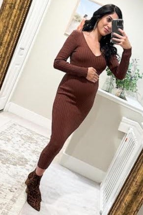 woman wearing a brown ribbed maternity dress, showing her baby bump, and paired with stylish leopard print ankle boots