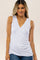 woman wearing a white sleeveless maternity top with a wrap style and slight ruching at the side