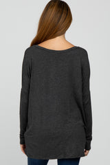 woman wearing a dark gray long sleeve maternity top, viewed from the back