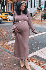 woman wearing a mauve ribbed maternity dress with long sleeves and a belted waist, showing her baby bump