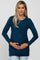 woman wearing a navy blue long sleeve maternity dress and holding her baby bump