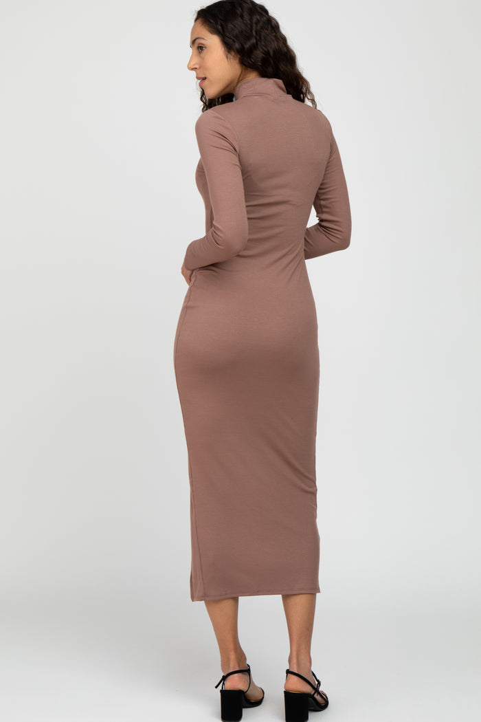 woman wearing a long sleeve mauve ribbed midi dress with a mock neck and black heels