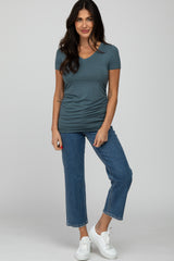 woman wearing a slate blue v-neck short sleeve top tucked into cropped jeans and white sneakers