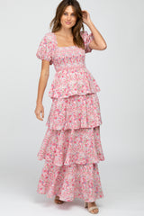 woman wearing a pink floral tiered maxi dress with puff sleeves and a square neckline