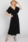 woman wearing a black maxi dress with a front knot detail and flutter sleeves, styled with a straw hat and sandals