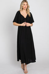 woman wearing a black maxi dress with a front tie detail and short sleeves