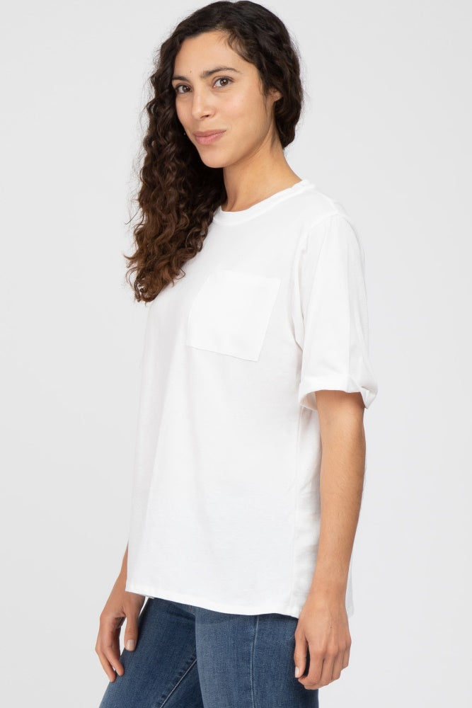 woman wearing a white short sleeve t-shirt with a pocket and relaxed fit, paired with blue jeans
