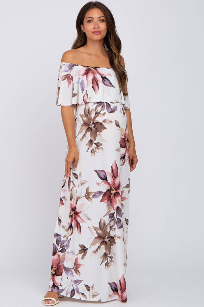 woman wearing a floral off-the-shoulder maxi dress, showcasing a baby bump, in a light color palette with pink and purple accents