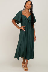 woman wearing a dark green midi dress with short flutter sleeves and a front knot detail
