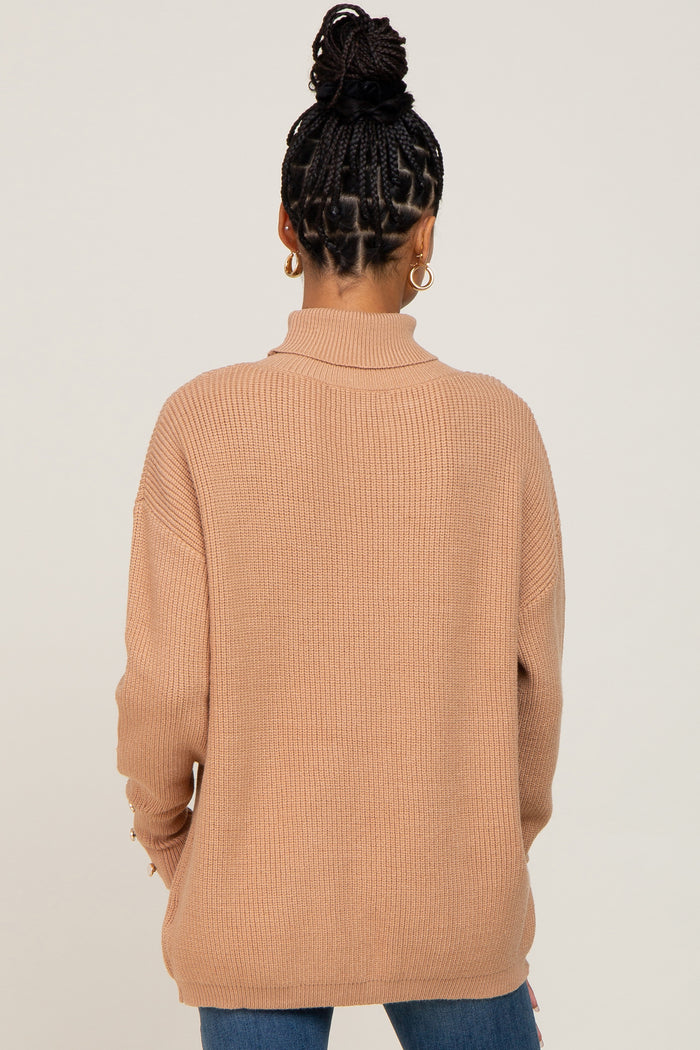 woman wearing a tan ribbed sweater with a high neck and long sleeves, viewed from the back
