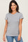 smiling woman wearing a grey short sleeve crew neck t-shirt and blue jeans